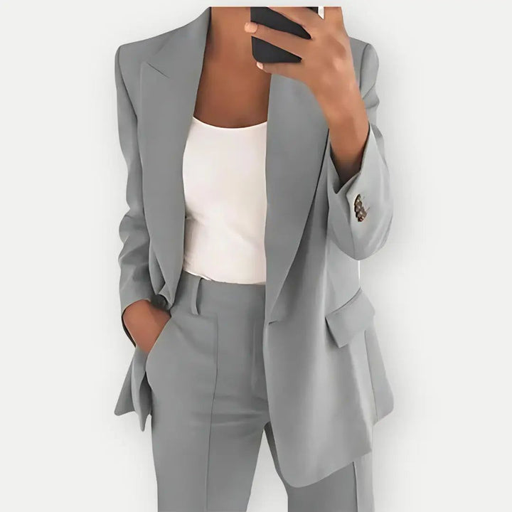 Matching two-piece women suit featuring a sleek blazer and trousers
