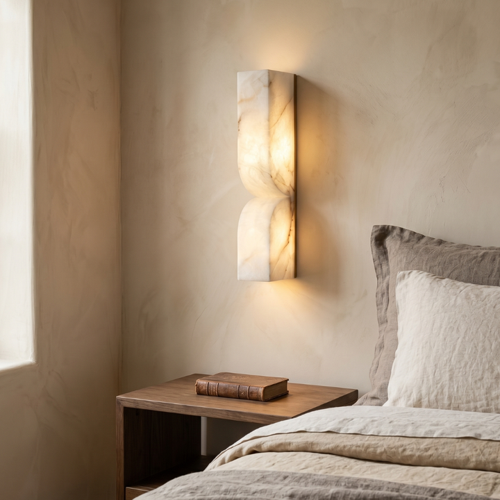 Side profile of a slim alabaster wall sconce showing its flush mount design