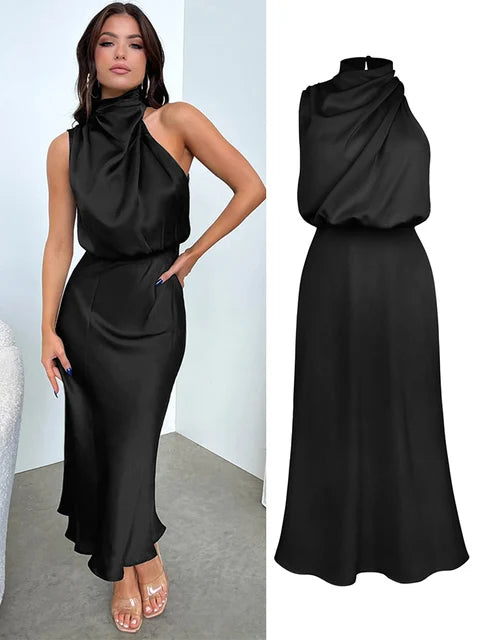 Woman wearing a black halter neck midi dress standing in front of a wall