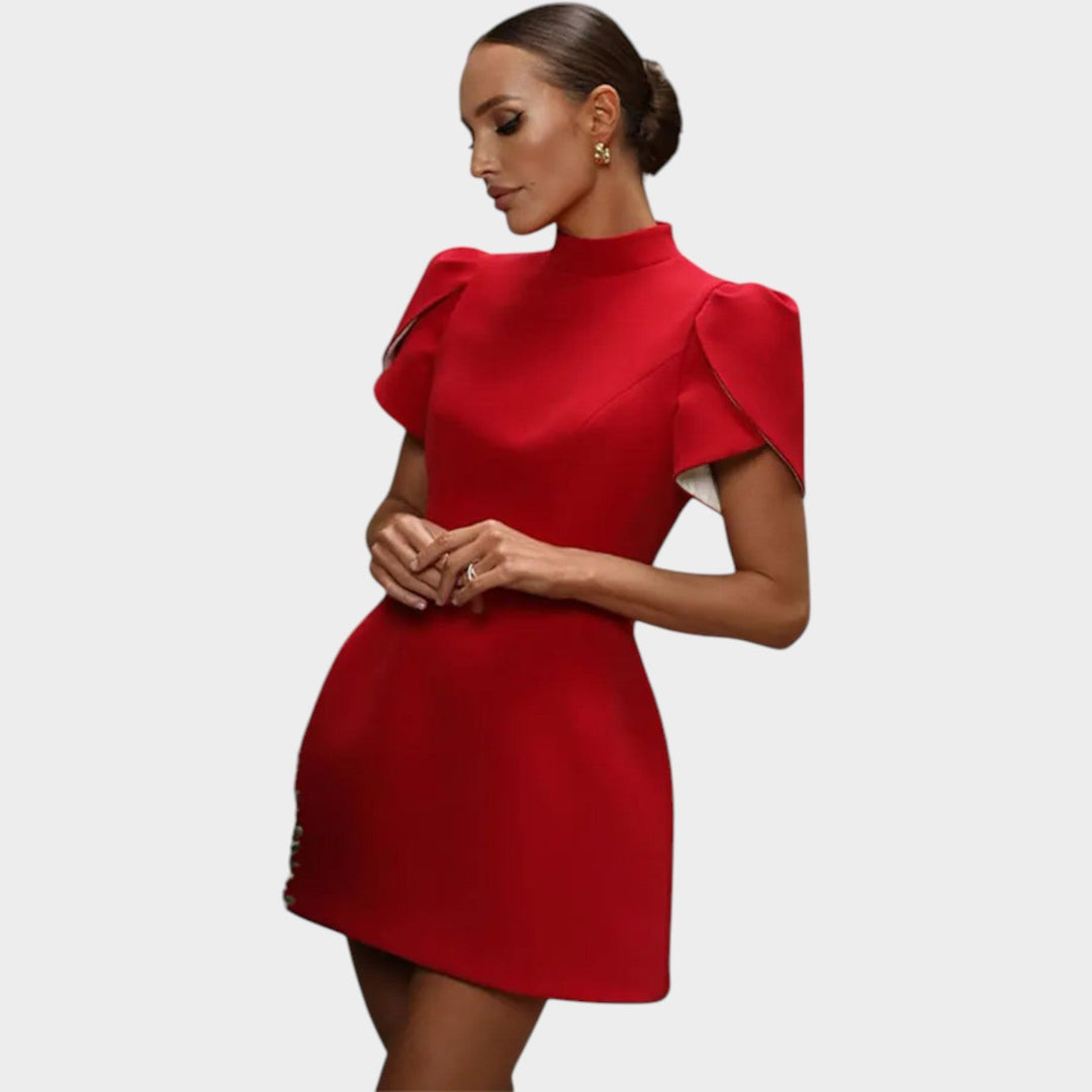 Model wearing a red mini dress with high neck and flutter sleeves from the front