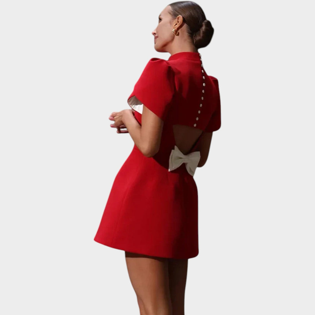 Back view of the red cocktail dress showing back details and mini length