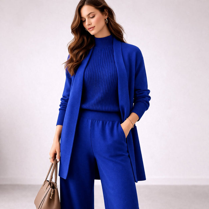 Full view of women's three-piece knit lounge set in soft neutral tone with wide leg pants