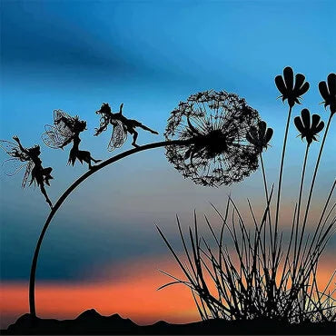 Silhouette of fairy sculptures playing on a dandelion in a garden