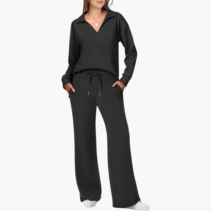 Model wearing black two-piece set featuring long sleeves and wide legs