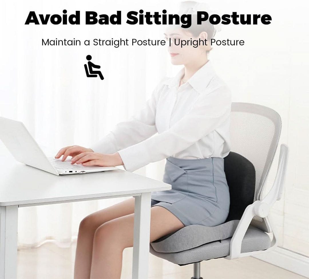 Person sitting upright at a desk using the ERGOREST back support cushion