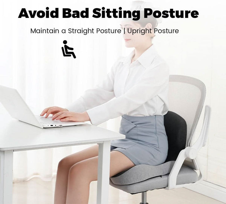 Person sitting upright at a desk using the ERGOREST back support cushion