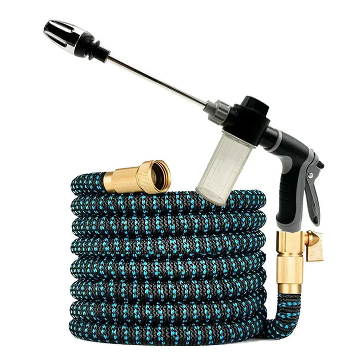Expandable garden hose rolled up next to a high pressure spray gun with foam container