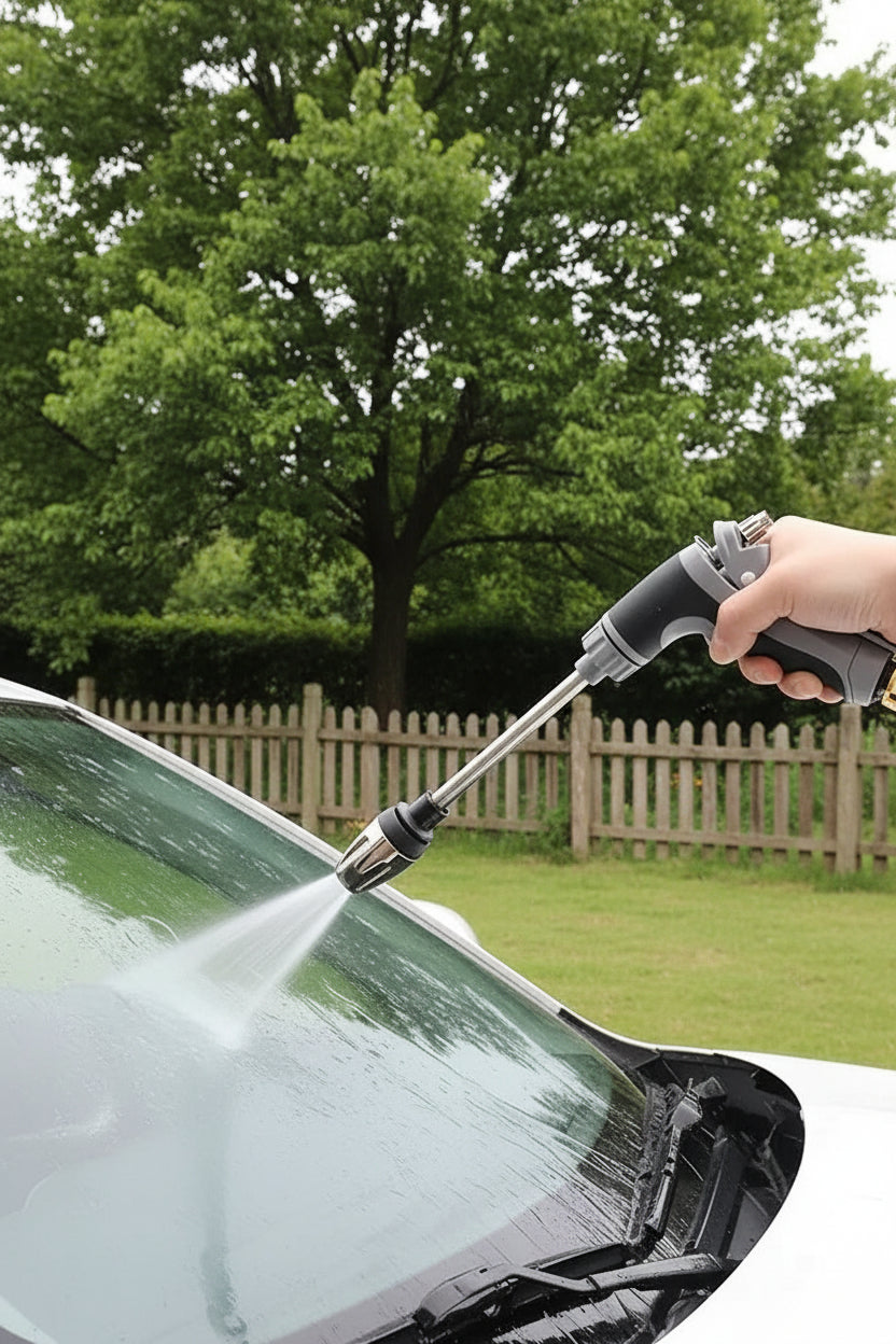 Person using the high pressure spray gun on a car windshield outdoors