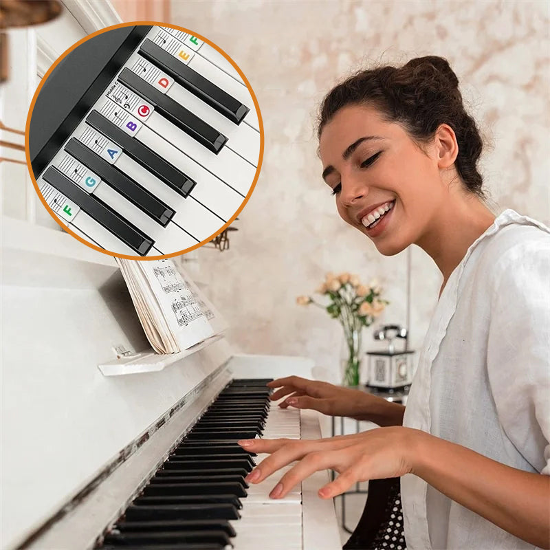 Smiling woman playing an upright piano equipped with removable note guide strips