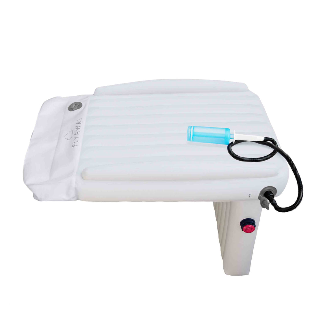 Parent inflating the portable travel bed for toddlers before a trip