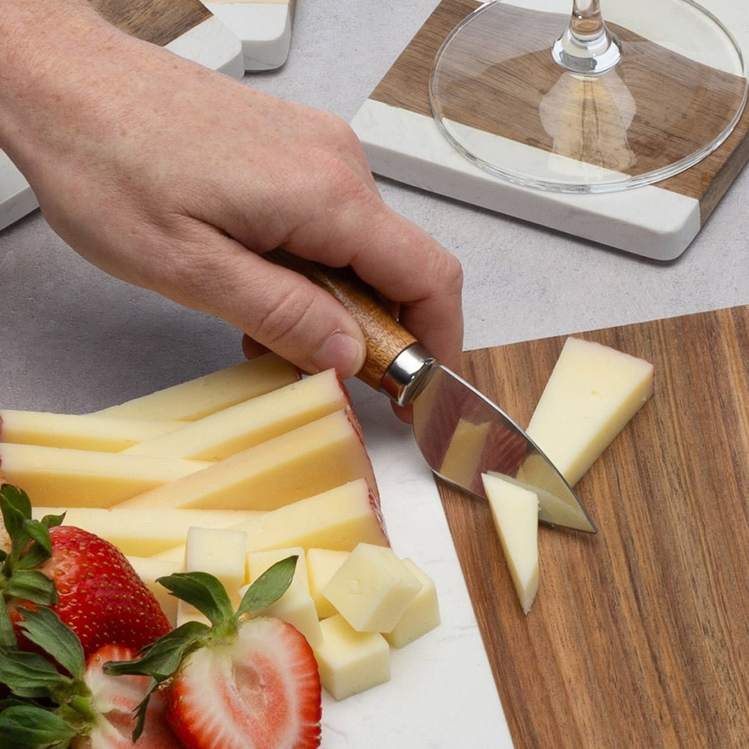 Four-piece cheese knife set with ergonomic wooden handles for charcuterie boards