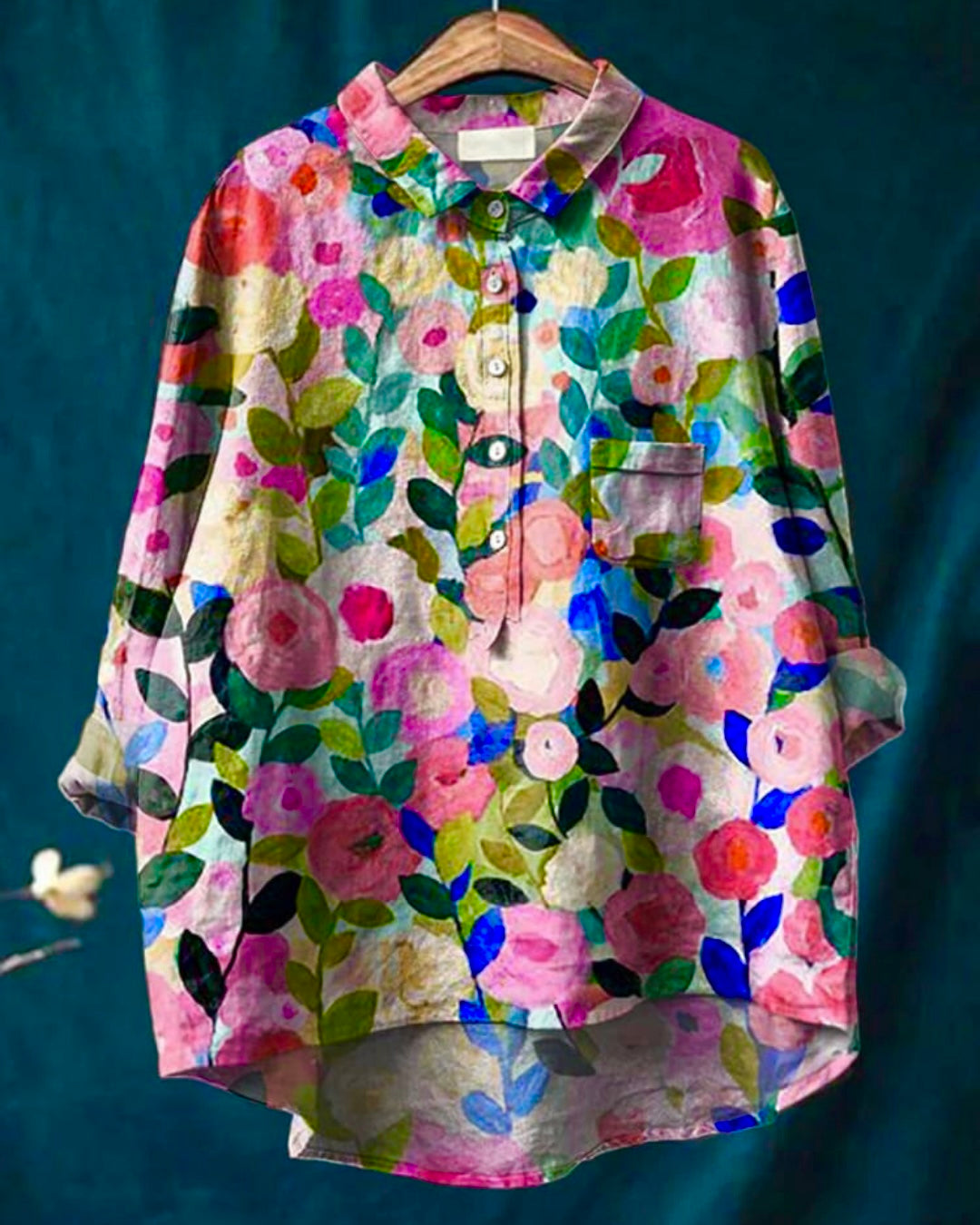 Floral print long sleeve button down blouse displayed on hanger