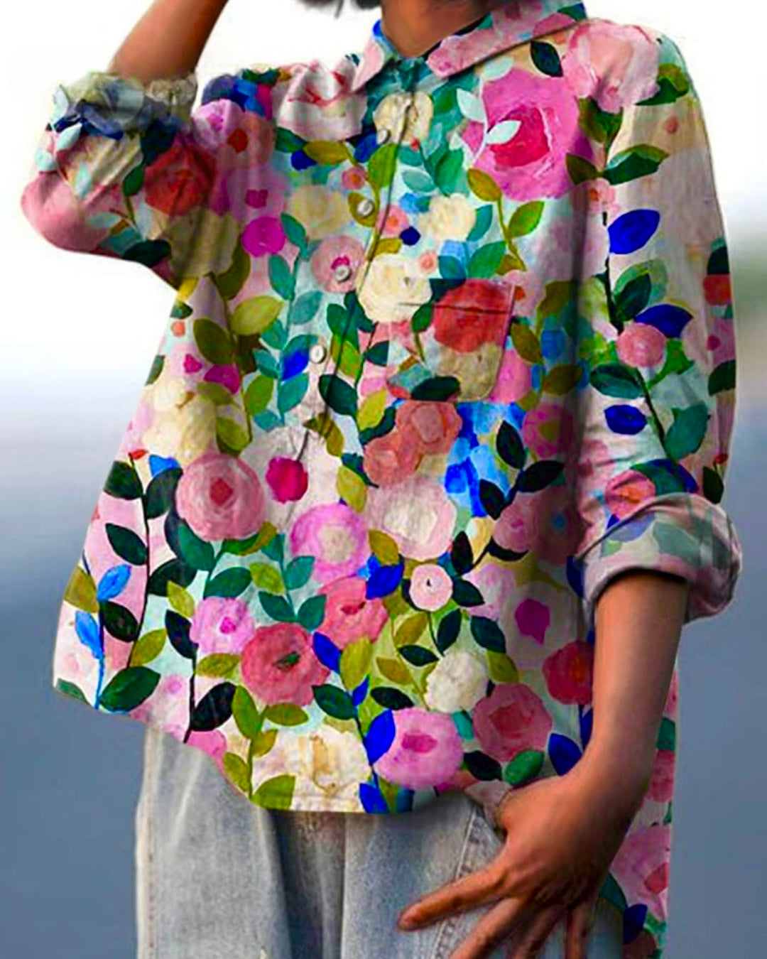 Woman wearing a vibrant floral print long sleeve button down blouse