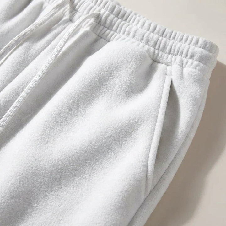 Close-up of soft fabric texture and elastic waistband on grey joggers