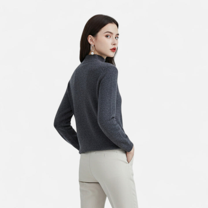 Back view of model wearing dark grey mock neck knit sweater