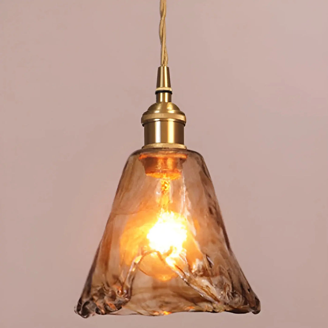 Amber glass pendant lamp casting a warm glow