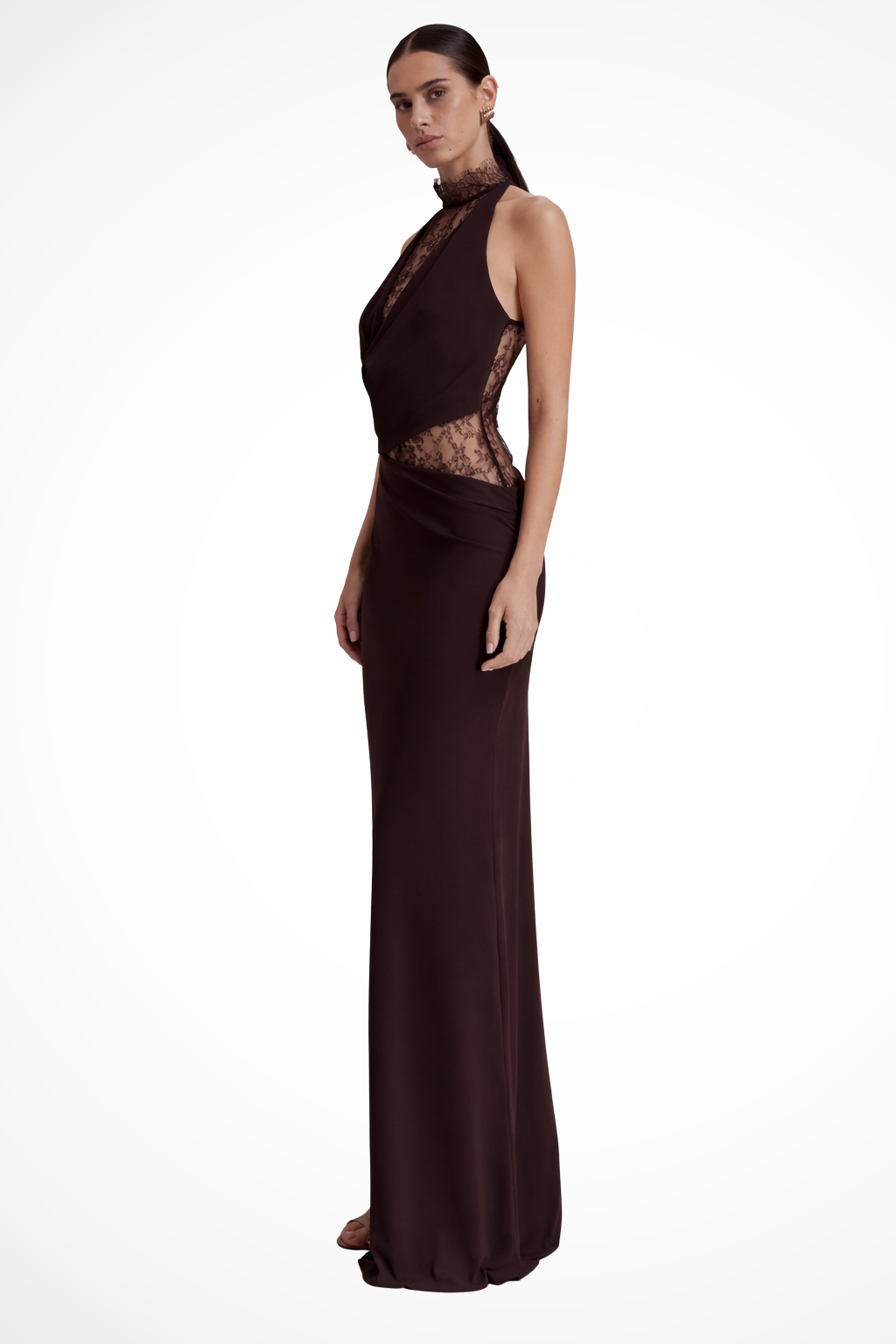 Close-up of elegant floral lace fabric on a dark brown sleeveless wedding guest maxi dress