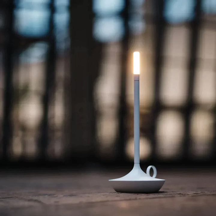 Modern rechargeable lighting accessory illuminating a stylish bookshelf