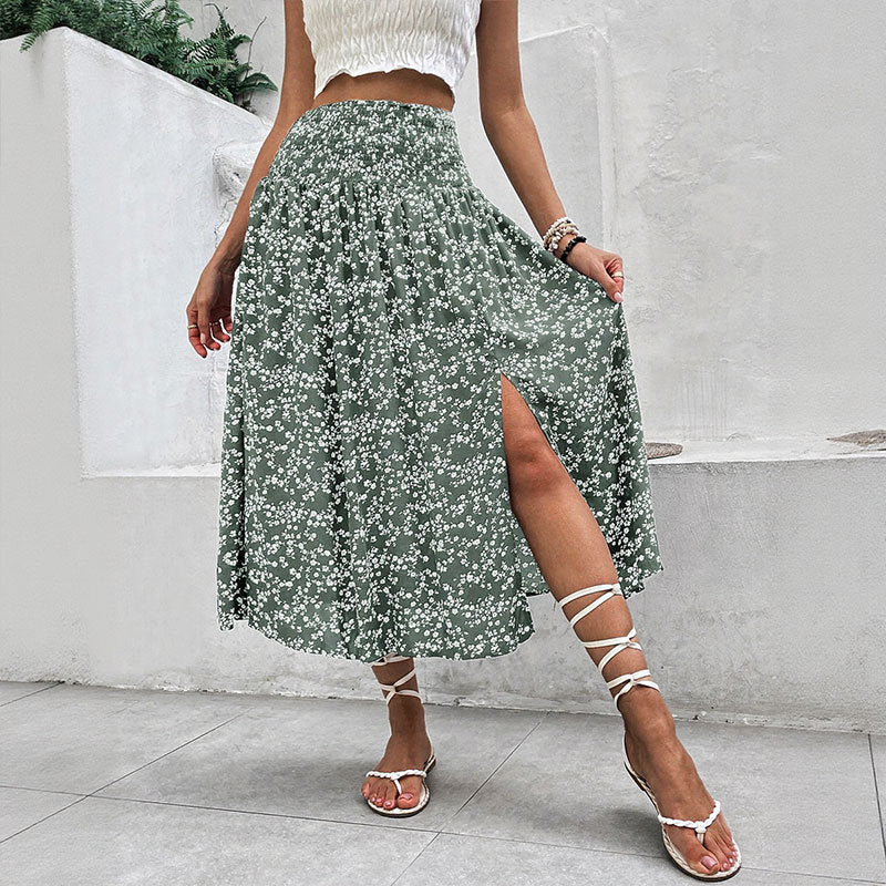 Model wearing green floral split midi skirt with front slit detail