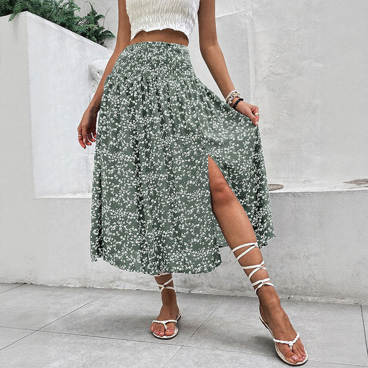 Model wearing green floral split midi skirt with front slit detail