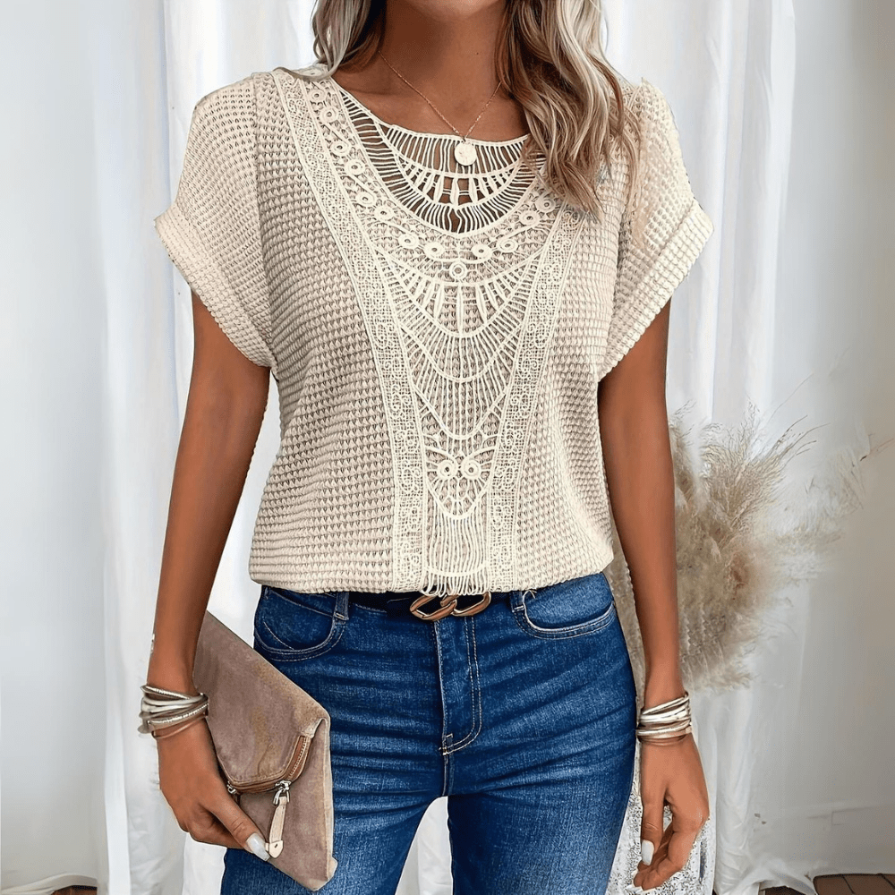 Woman wearing beige vintage lace detail top with blue jeans