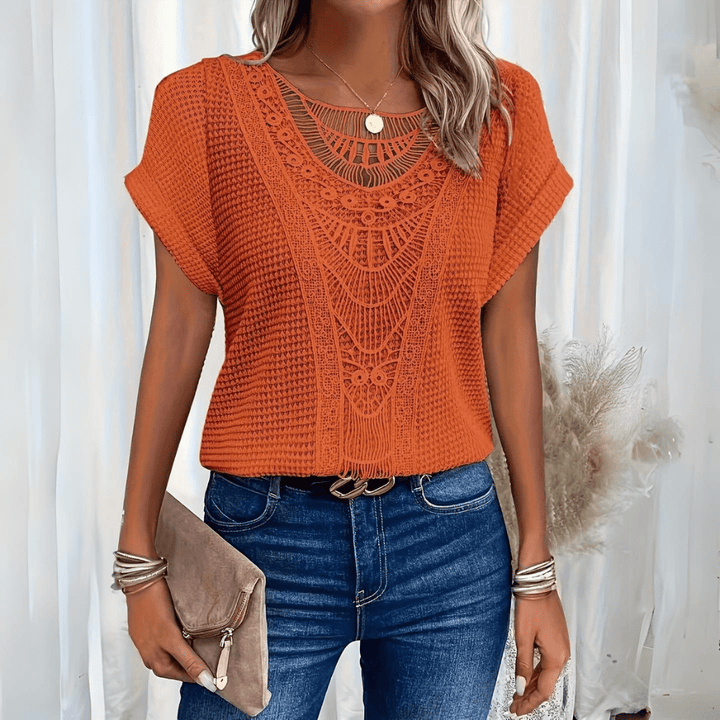 Close up of intricate lace trim on the short sleeve summer top
