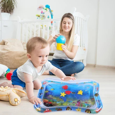 Infant playing on colorful aqua tummy time mat with floating sea toys
