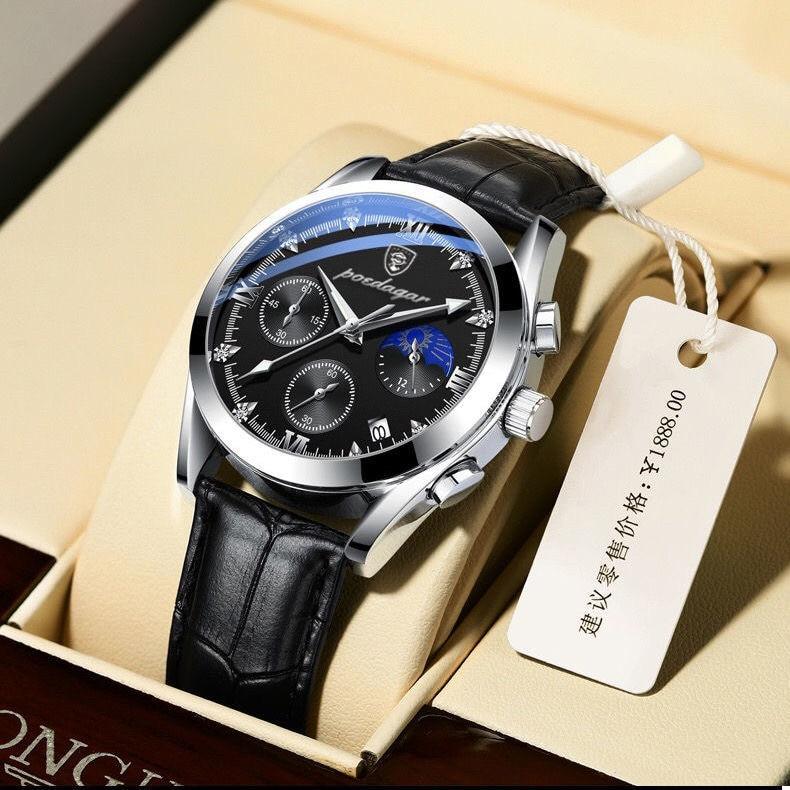 Men's analog watch resting flat on a leather surface displaying its band