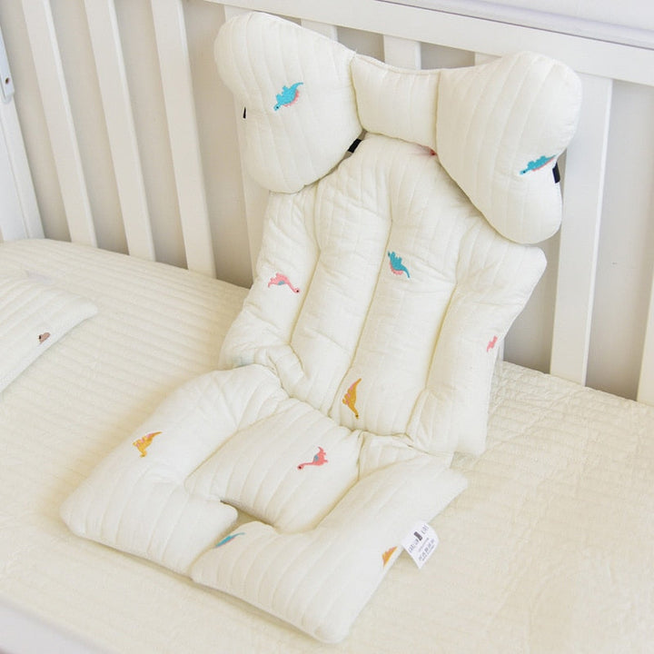 Soft baby stroller cushion featuring a playful dinosaur print pattern
