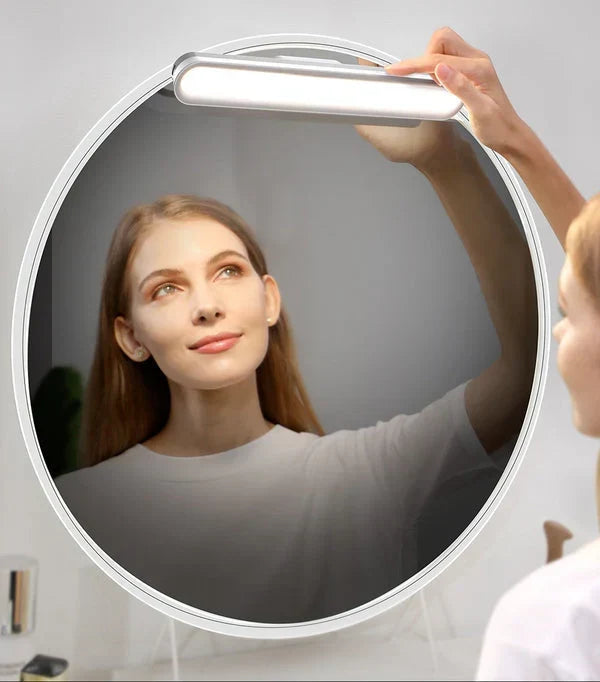 Portable magnetic cordless desk lamp angled sideways to show slim profile