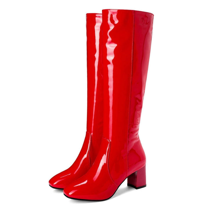 Side view of women's glossy knee-high boots with block heel and autumn footwear style