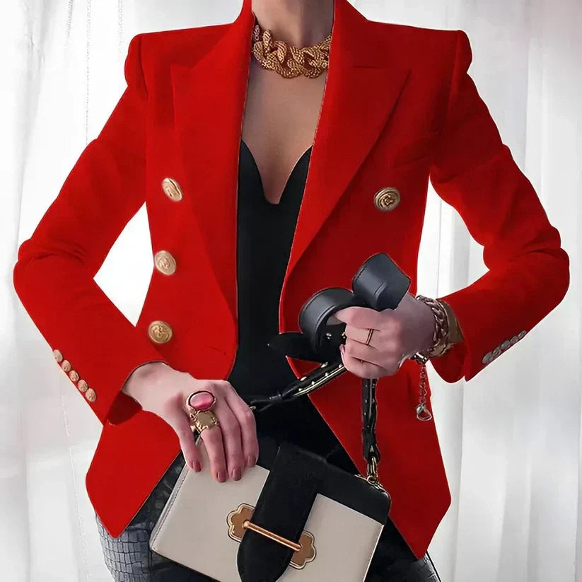 Woman modeling a vibrant red tailored double-breasted blazer with structured shoulders