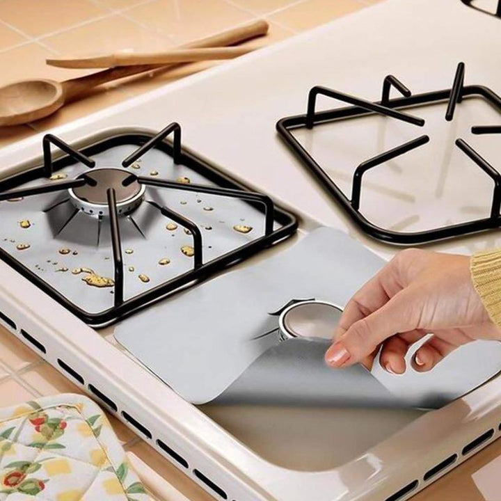Gas stove protector mat being wiped clean easily with a damp sponge