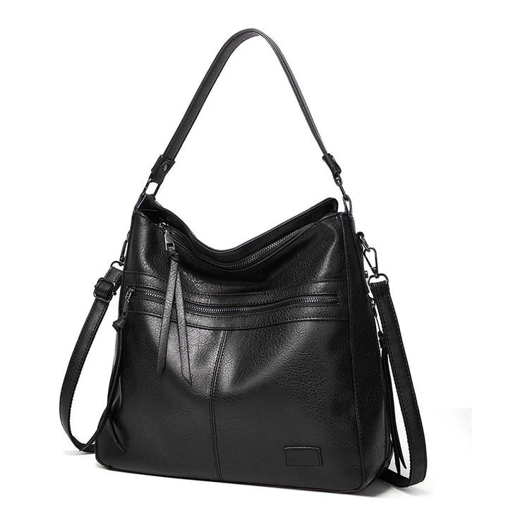 Chic black women's luxury shoulder bag closeup showing premium texture and hardware