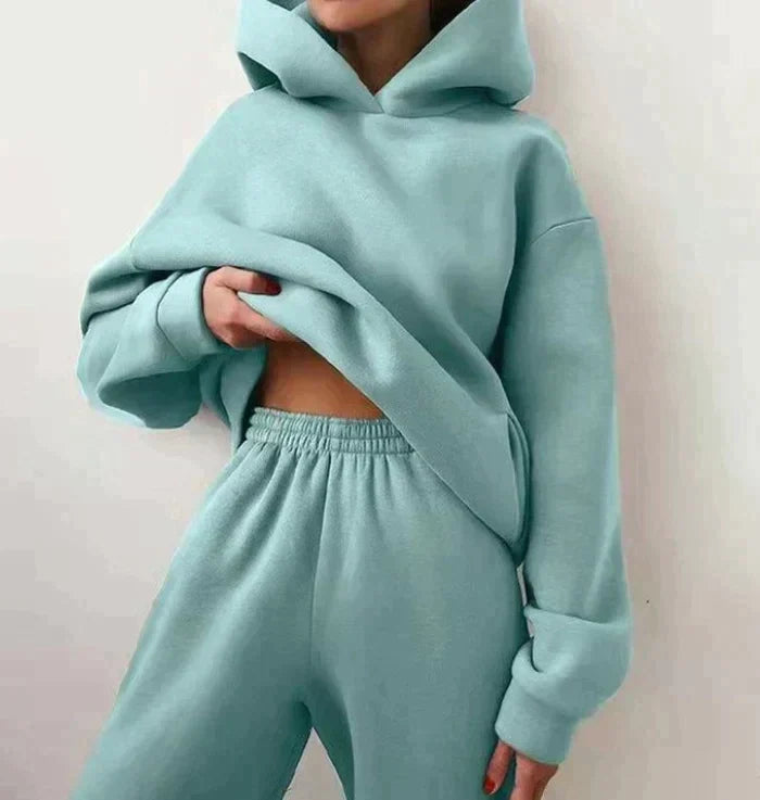 Woman wearing a light green hooded jogging set