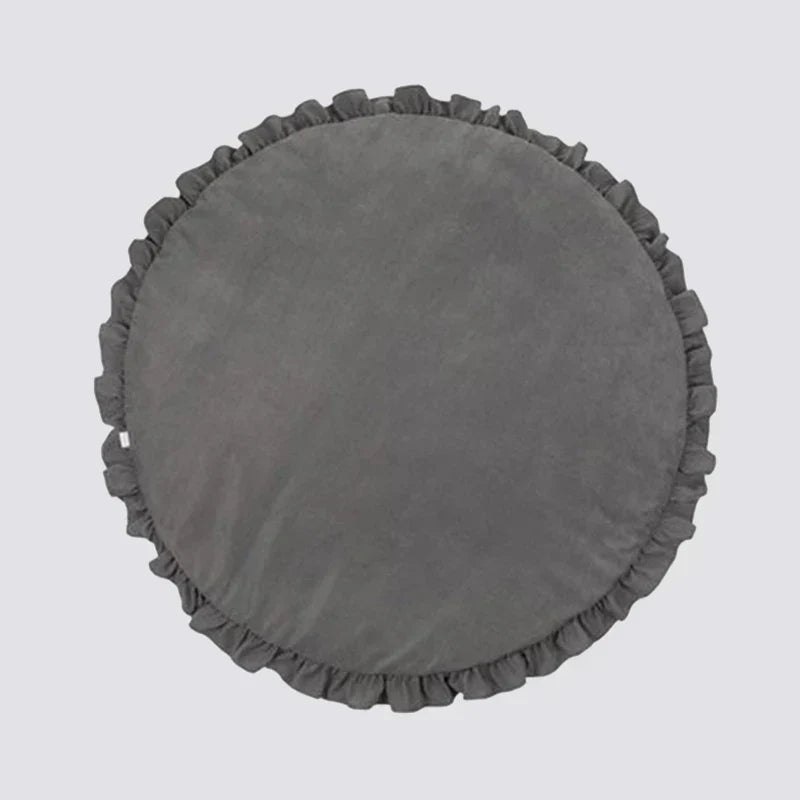 Top view of the round baby play mat set up in a bright nursery