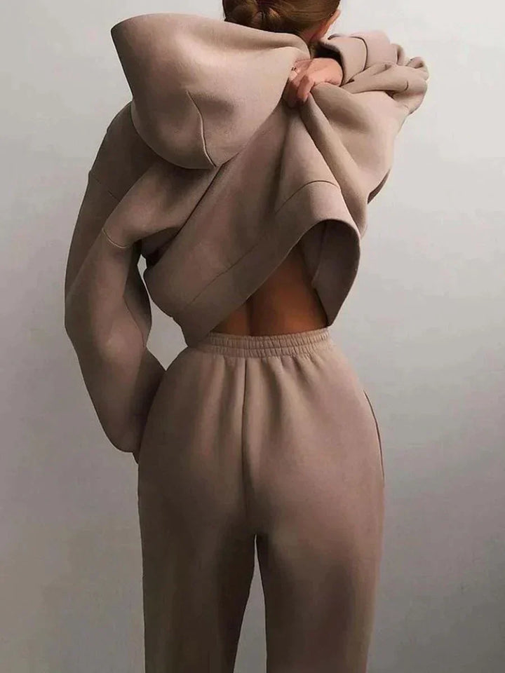 Back view of a woman wearing a lounge hoodie and sweatpants