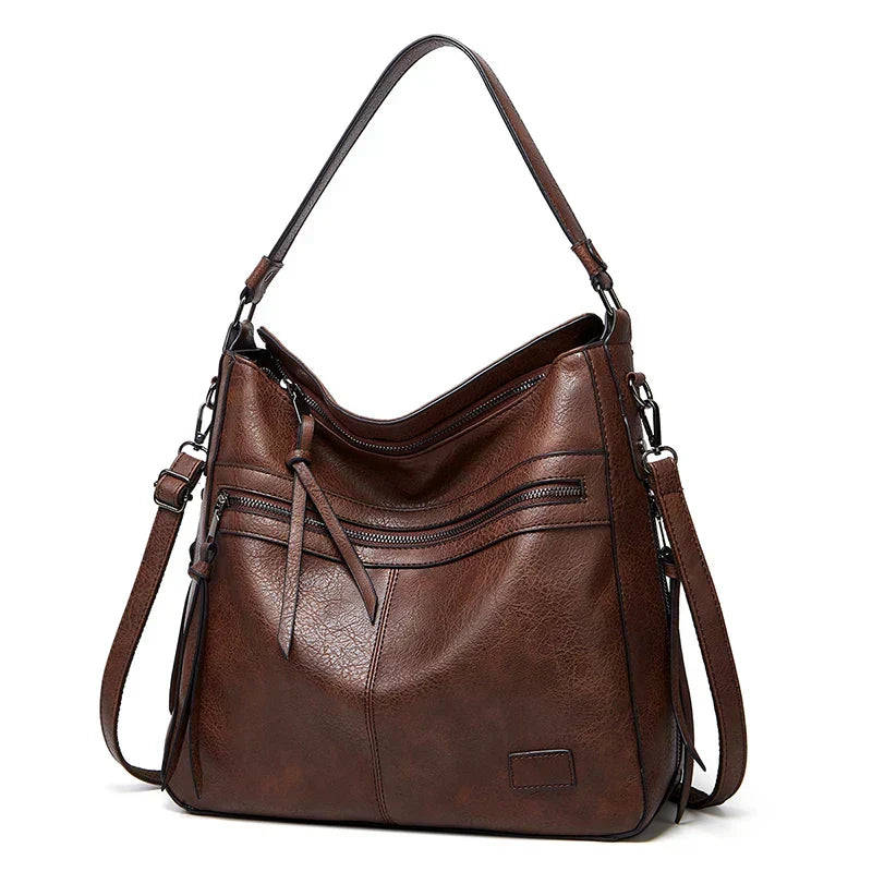 Luxury brown leather handbag featuring a durable strap and elegant design