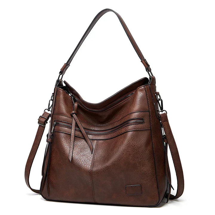 Luxury brown leather handbag featuring a durable strap and elegant design