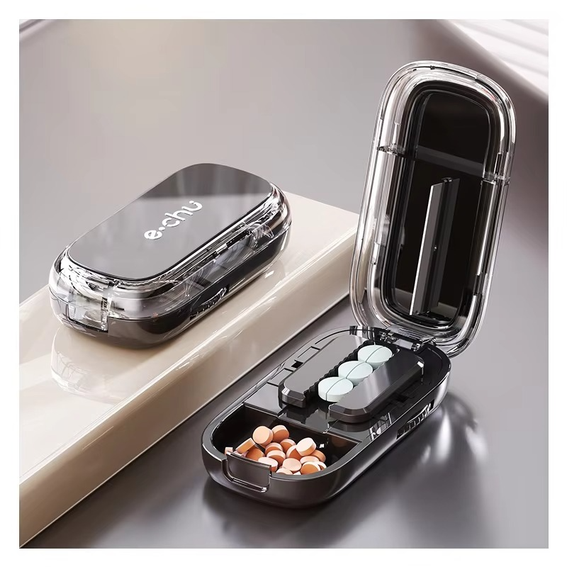 Close-up of the pill splitter lid open, highlighting the V-shaped grip for secure pill holding.