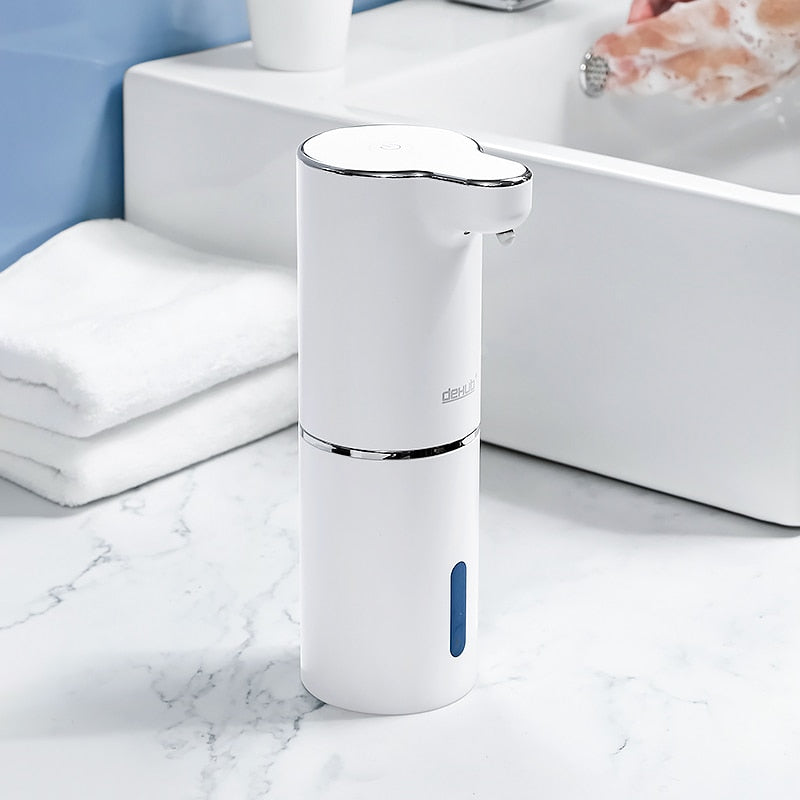 Automatic foaming soap dispenser near a modern white bathroom sink