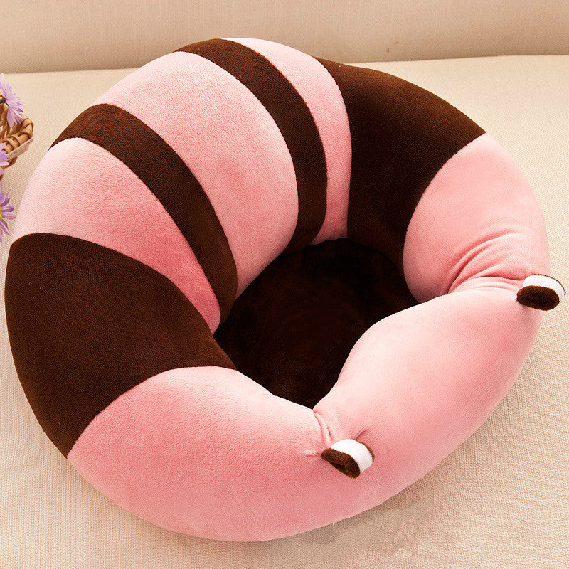 Pink and brown striped baby support seat on a neutral surface