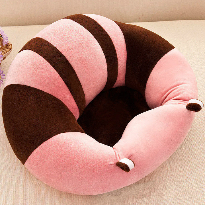 Pink and brown striped baby support seat on a neutral surface