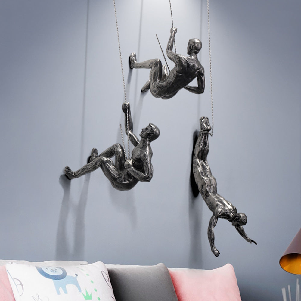 Set of resin sculpture mountaineers creating an adventurous living room focal point