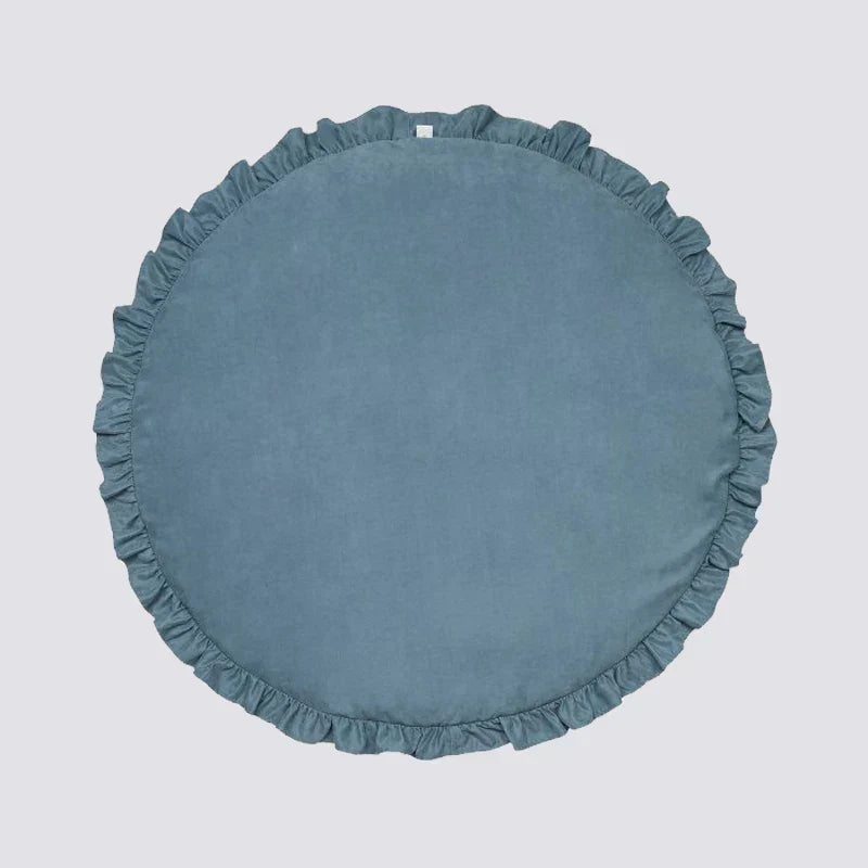 Child playing with toys on the comfortable round nursery mat