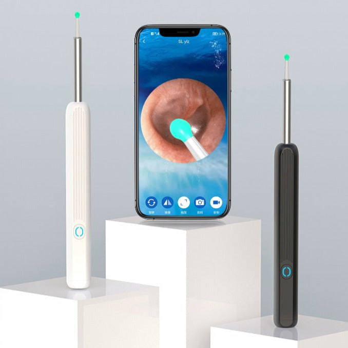 White and black smart ear wax cleaning tools displayed next to a phone screen