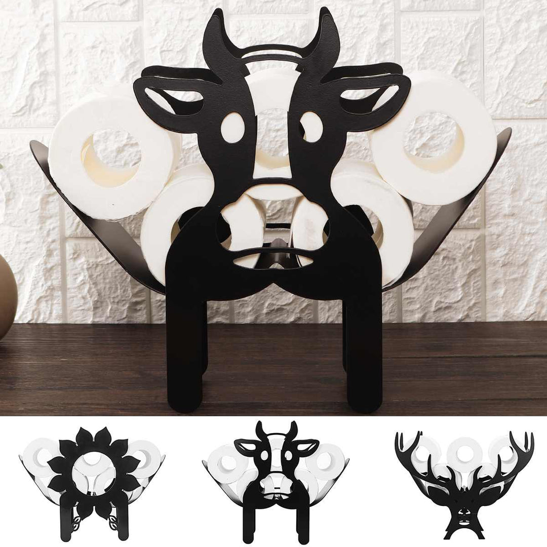 Cow design metal toilet paper holder mounted on a white brick wall