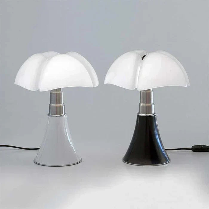 White and black flower table lamps displayed side by side on a clean surface