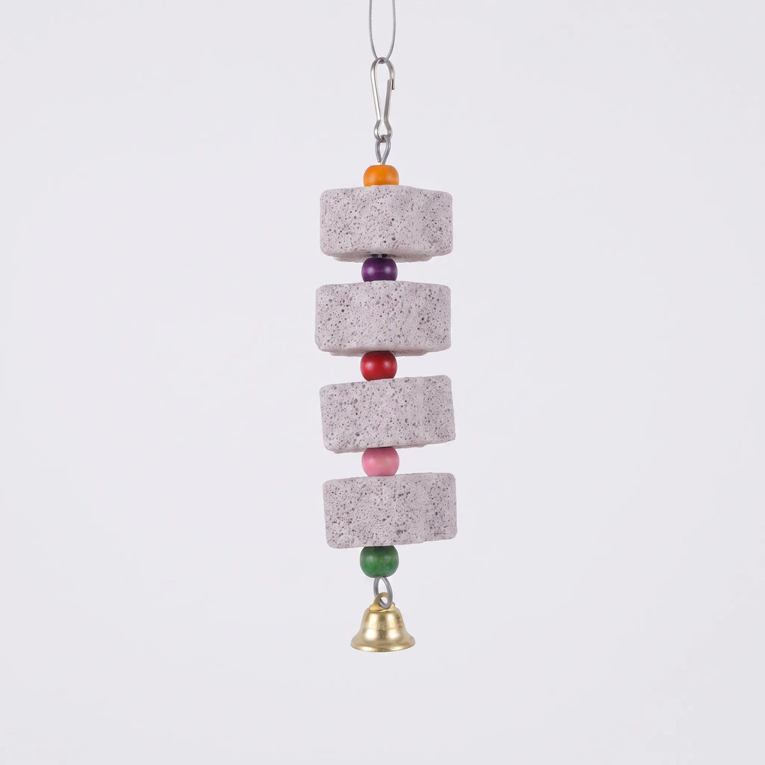 Hanging bird toy with flower-shaped mineral blocks and a bell against a white background