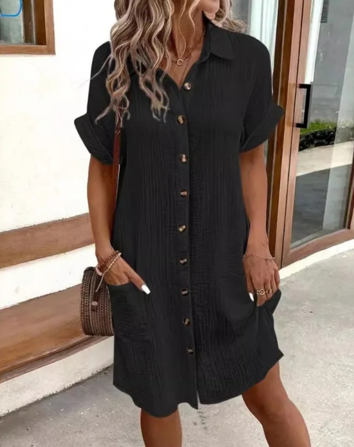 Woman wearing a black casual button-down shirt dress